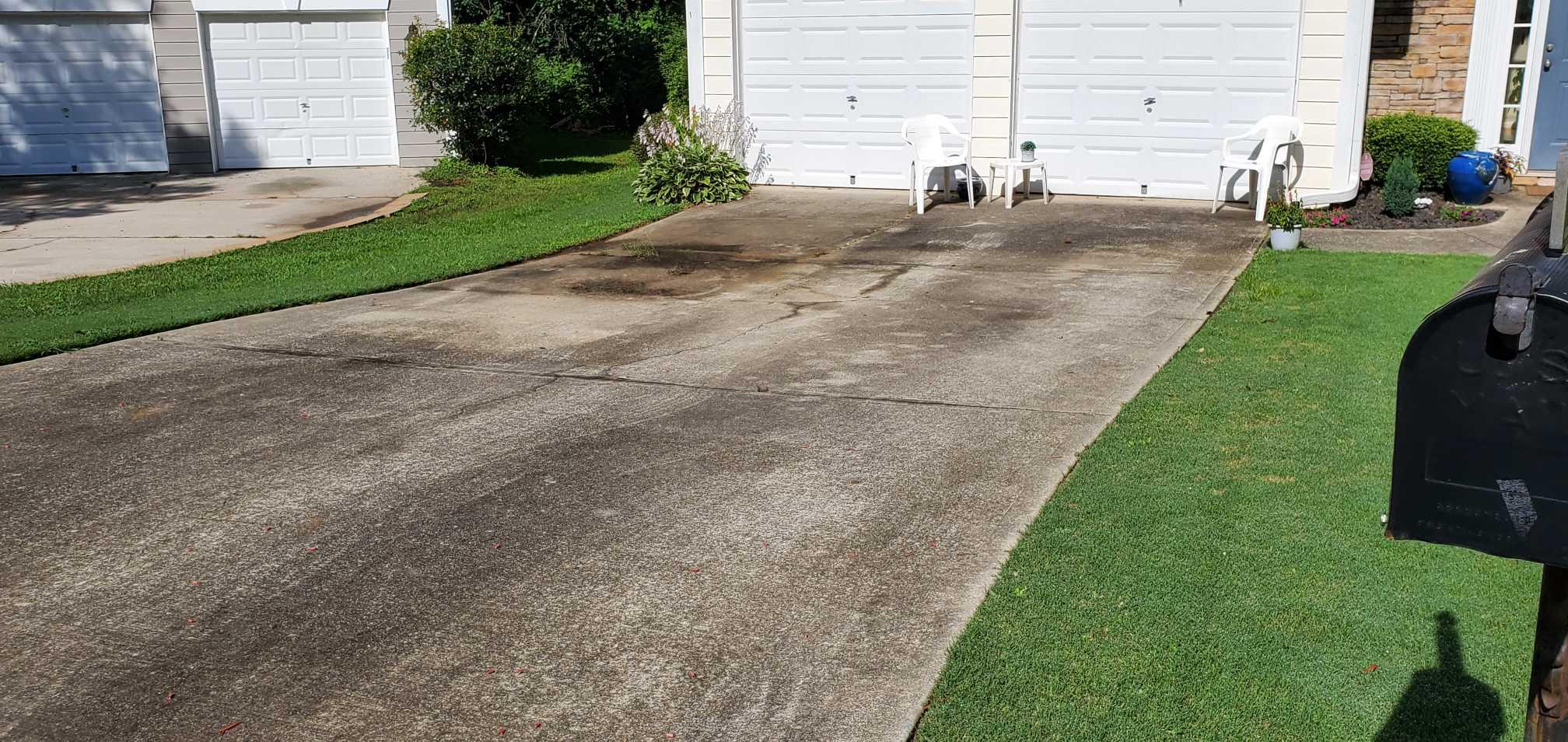 Stained residential driveway in Springfield, OR before pressure washing