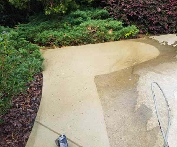 Surface cleaner mid-job on a curved walkway